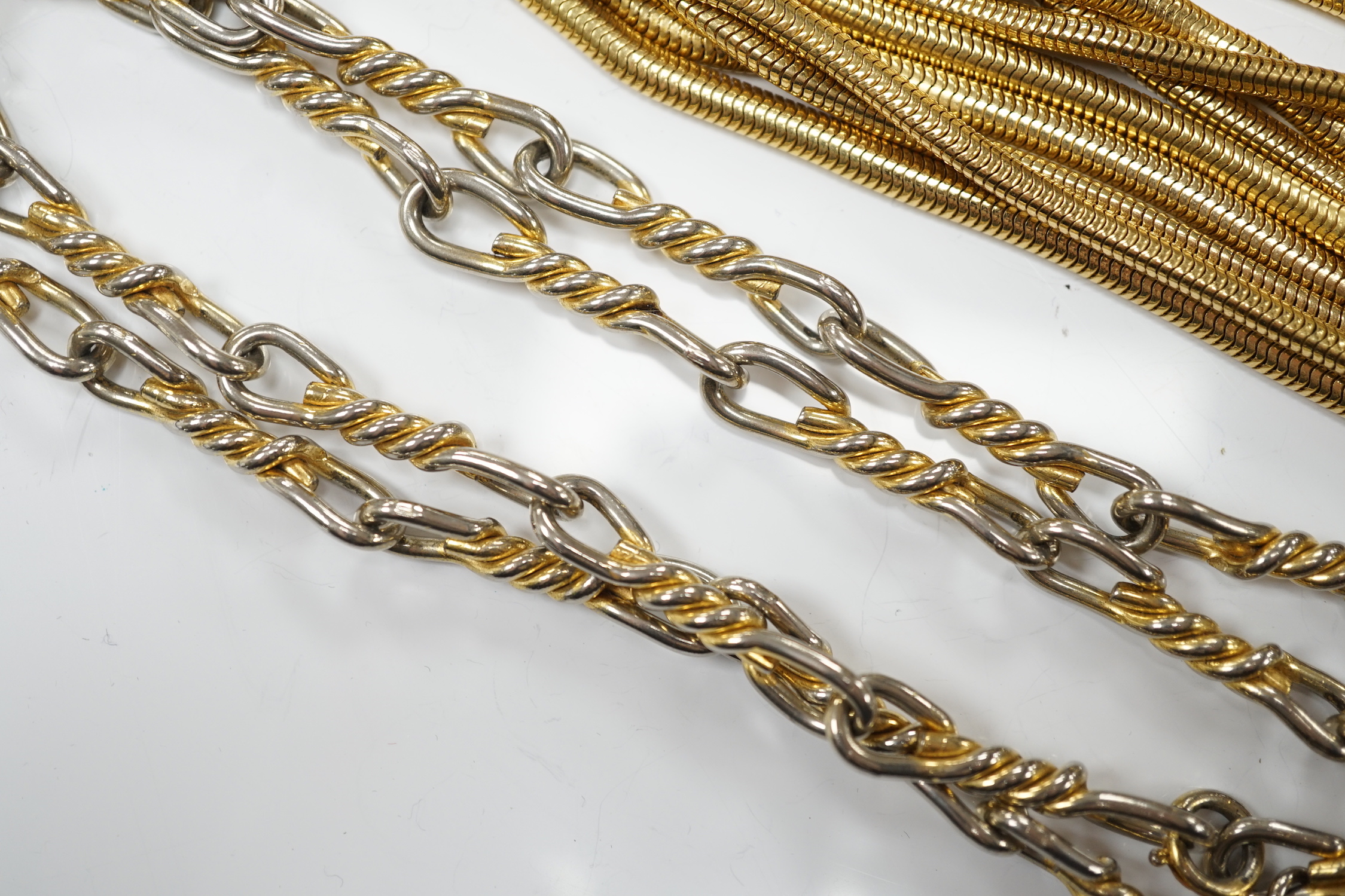 A Christian Dior multi strand gilt metal snake link necklace, 90cm, together with a Christian Dior two colour metal spiral chain link necklace, 78cm, both signed.